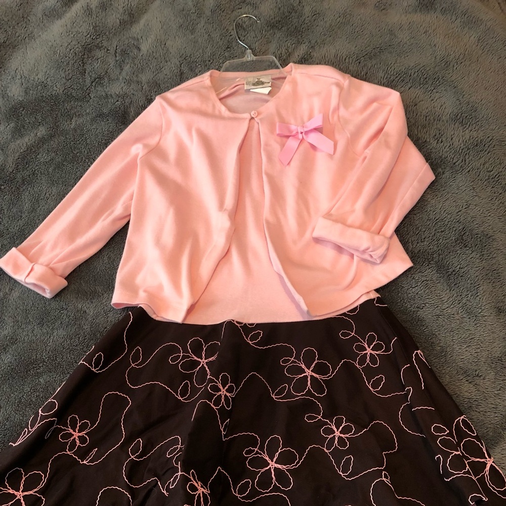A kids sleeveless dress with cardigan